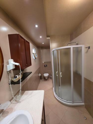 a bathroom with a shower and a sink at Meridian Hotel in Budva