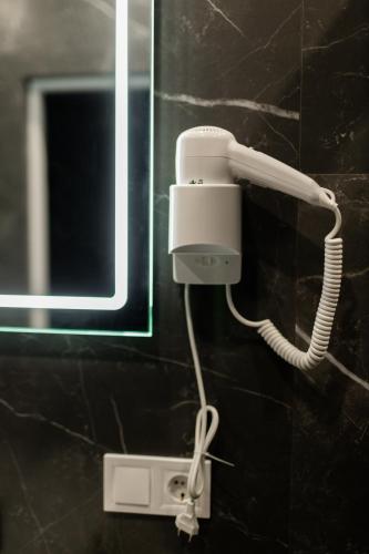 a white phone on a wall in a bathroom at Краєвид in Slavske
