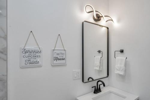 a bathroom with a sink and a mirror and towels at Sleeps 24-spacious Suites Near Fq W Pool in New Orleans