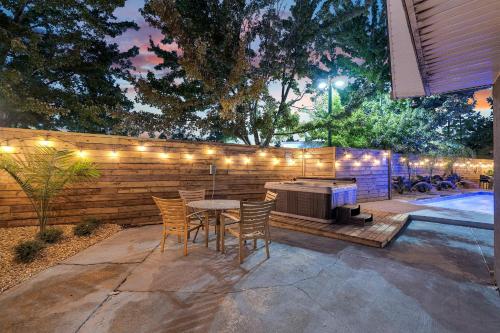 a patio with a table and chairs next to a fence at Sleeps 24-spacious Suites Near Fq W Pool in New Orleans