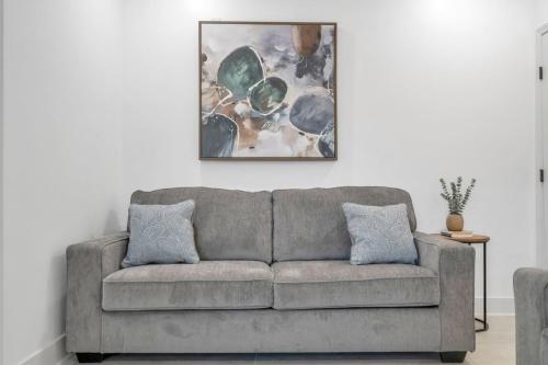 a couch in a living room with a painting on the wall at Sleeps 24-spacious Suites Near Fq W Pool in New Orleans