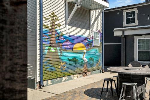 a mural on the side of a building with a table at Sleeps 24-spacious Suites Near Fq W Pool in New Orleans
