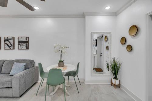 a living room with a couch and a table and chairs at Sleeps 24-spacious Suites Near Fq W Pool in New Orleans