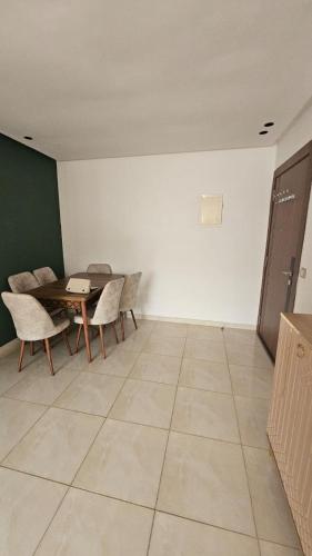 a dining room with a table and chairs at Bright and Cosy appartment in Oulad Yakoub