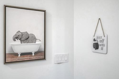 a picture of an elephant in a bath tub on a wall at Sleeps 24-spacious Suites Near Fq W Pool in New Orleans