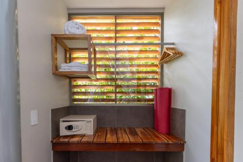 a room with a window filled with wine bottles at Cielo Lodge in Golfito