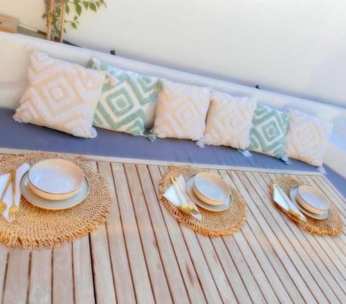 a table with plates and cutlery on a bed at Alemarni Syros in Ermoupoli