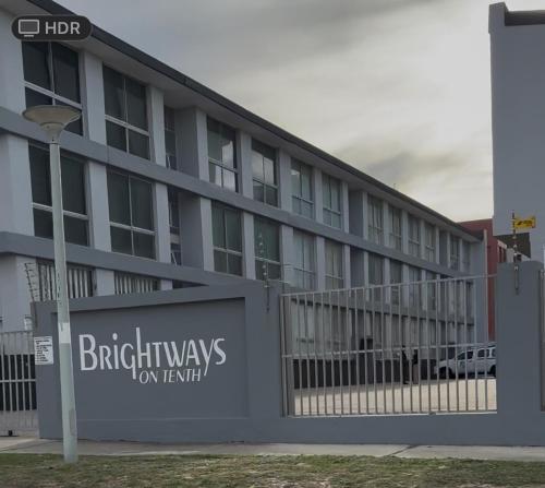 a building with a sign on the side of it at Brightways AirB&B in Summerstrand