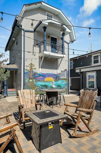 a picnic table and chairs in front of a house at Sleeps 24-spacious Suites Near Fq W Pool in New Orleans