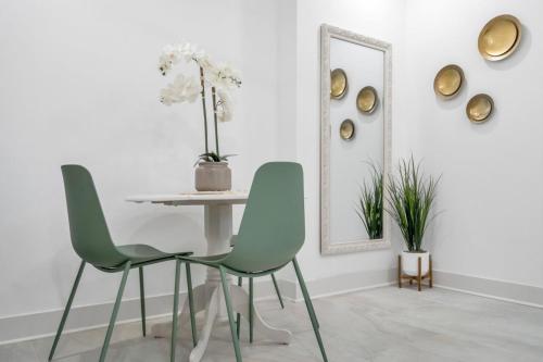 a dining room with two chairs and a table and a mirror at Sleeps 24-spacious Suites Near Fq W Pool in New Orleans
