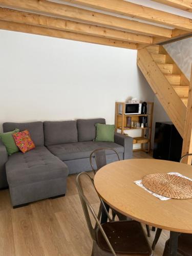a living room with a couch and a table at Posada La Fontana in Santillana del Mar