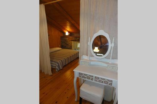 a room with a mirror and a table and a bed at villapetramarina in Tsakaíoi