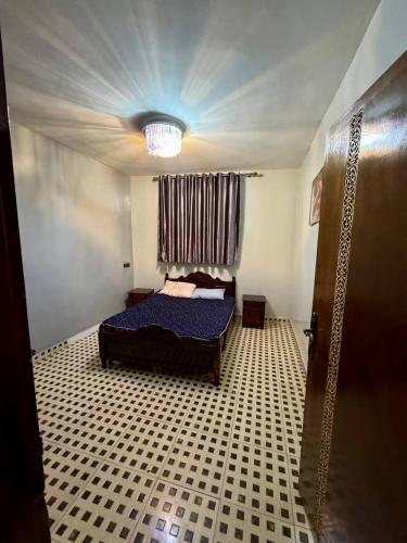 a bedroom with a bed in a room with a ceiling at Appartement Vue Mer Tamraght in Tamraght Oufella