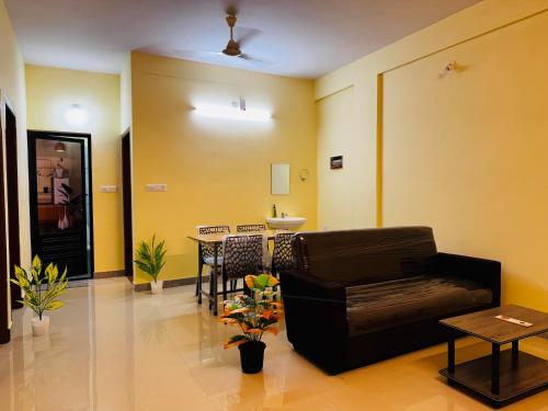 a living room with a couch and a table at AL-Kabeer Cybernest apartments Infosys in Trivandrum