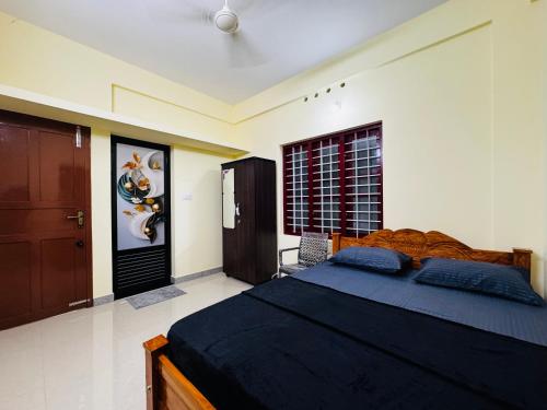 a bedroom with a large bed and a window at AL-Kabeer Cybernest apartments Infosys in Trivandrum