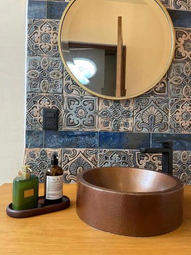 a bathroom with a sink and a mirror on a counter at Casa Cairo Pátzcuaro in Pátzcuaro