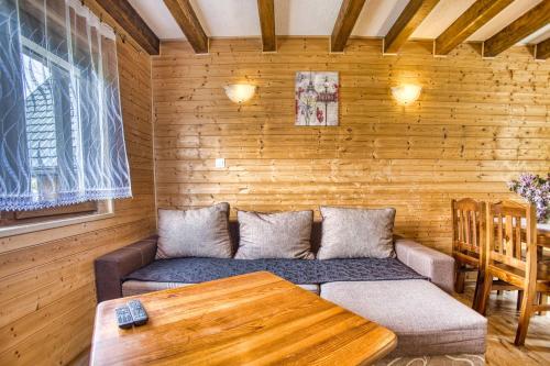 a living room with a couch and a table at Domki u Piotra in Solina