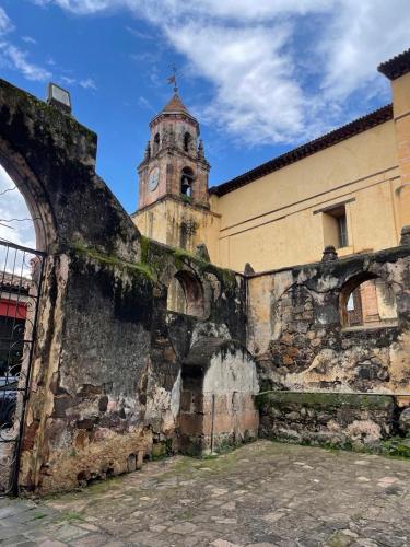 an old building with a clock tower in the background at Casa Cairo Pátzcuaro in Pátzcuaro