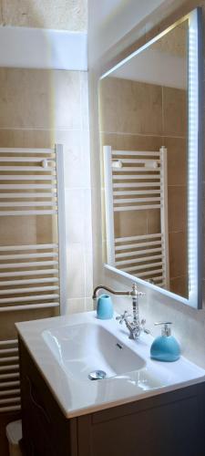 a bathroom with a sink and a mirror at Petrabianca di San Cesario di Lecce in San Cesario di Lecce