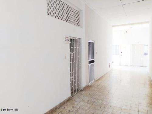 an empty room with white walls and a hallway with doors at alojamiento centro histórico - 3-2 in Cartagena de Indias