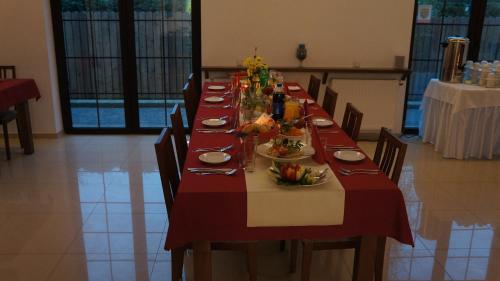 a long table with plates of food on it at GOŚCINIEC NAD NARWIĄ - Airport Modlin in Kikoły