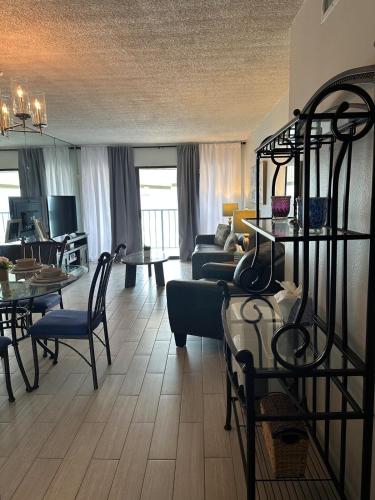 a living room with a couch and a dining room at Panoramic Ocean View Condo in Galveston