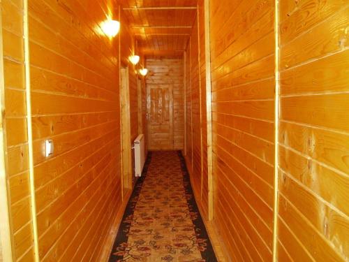 a hallway of a wooden room with wooden walls at Pension Bran Ioana& SPA in Bran