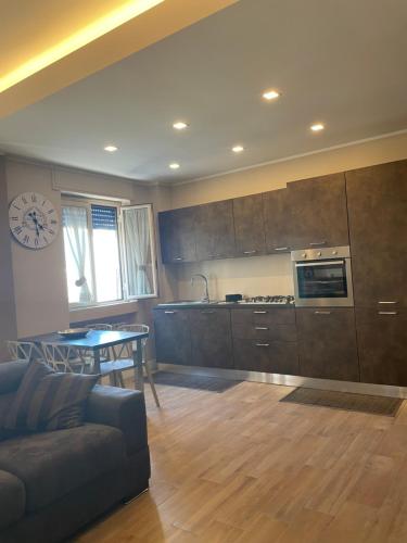 a kitchen with a couch and a table in a room at Home Dreams in Cosenza