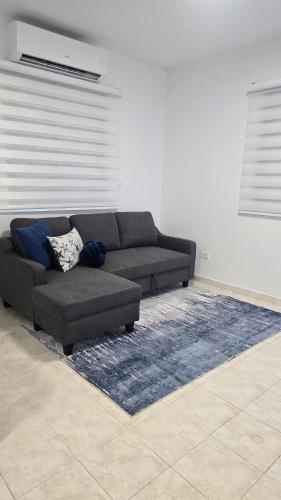 a living room with a couch and a rug at BioBay Suite Los Roires Beach Apartments in Fajardo
