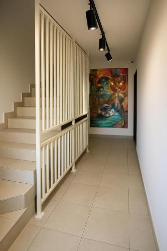 a hallway with stairs and a painting on the wall at Arena 7-17 Central Suites in Cluj-Napoca