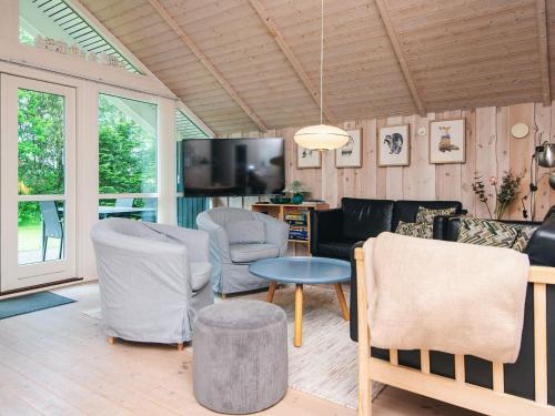 a living room with a couch and chairs and a tv at 6 person holiday home in Hemmet-By Traum in Hemmet