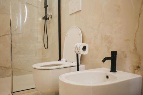 a bathroom with a toilet and a sink and a shower at Dalia Suite & Relax in Polignano a Mare