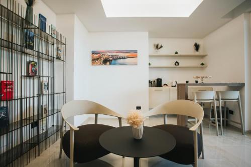a dining room with two chairs and a table at Dalia Suite & Relax in Polignano a Mare