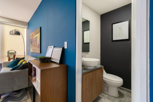 a bathroom with a toilet and a sink at San Ángel modern luxury in Mexico City