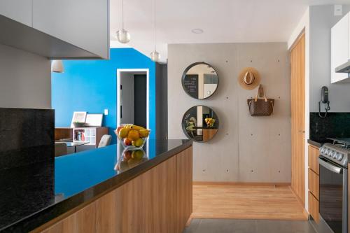 a kitchen with a counter with a bowl of fruit on it at San Ángel modern luxury in Mexico City