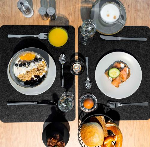 a table topped with plates of breakfast foods and drinks at Apartment in Lam - Bayerischer Wald 50007 in Lam