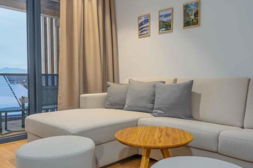 a living room with a white couch and a table at Apartment in Lam - Bayerischer Wald 50007 in Lam