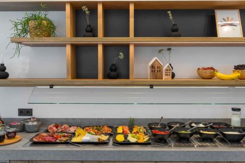 a buffet with many plates of food on a counter at Apartment in Lam - Bayerischer Wald 50007 in Lam
