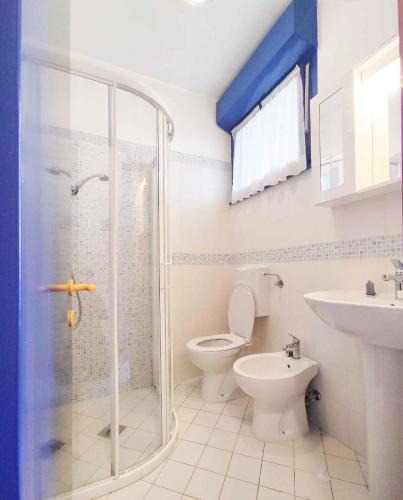 a bathroom with a shower and a toilet and a sink at Apartment in San Michele al Tagliamento 45664 in San Michele al Tagliamento