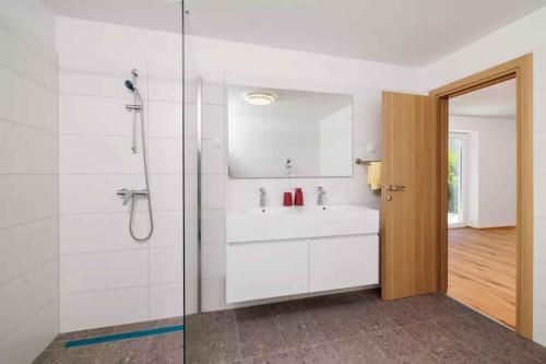 a white bathroom with a sink and a shower at Holiday home in Tribalj 51443 in Tribalj