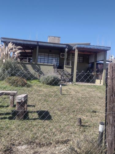a house with a fence in front of it at El mirador in Villa Yacanto