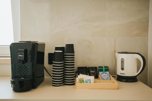 a desk with a computer monitor and a coffee maker at Dalia Suite & Relax in Polignano a Mare