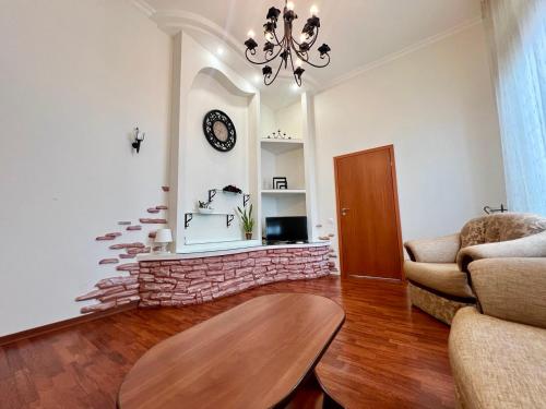 a living room with a brick fireplace with a clock at Апартаменты на Крещатике in Kyiv