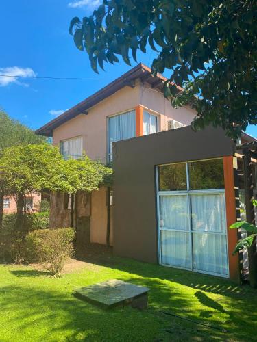 a house with a green lawn in front of it at Paraiso Colon in Colón