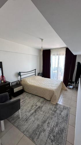 a bedroom with a bed and a large rug at Kyrenia 2 bedroom apartment in Ayios Dhometios