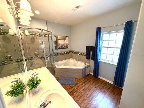 a bathroom with a tub and a sink and a shower at Lakefront and Lake View Condo on Indian Point in Branson