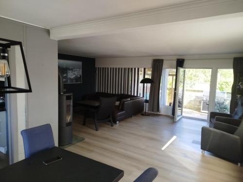 a living room with a couch and a table at Margaret's Home in Nøtterøy