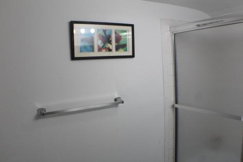 a bathroom with a shower and a picture on the wall at Southend Gem in Hartford