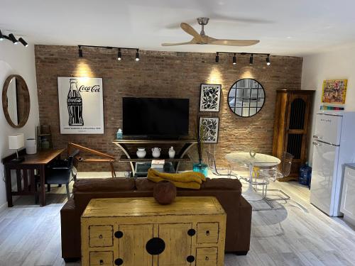 a living room with a couch and a tv at Park Slope New Pvt 2 bdrm in Brooklyn