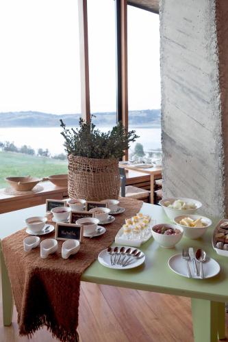 a table with bowls and plates of food on it at Refugia Chiloé in San José